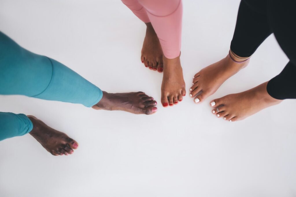 Unrecognizable barefoot women with pedicure