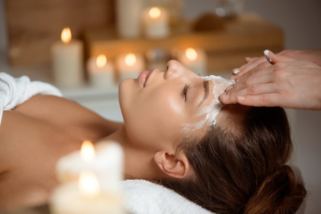 Young beautiful girl in mask for face relaxing in spa salon.